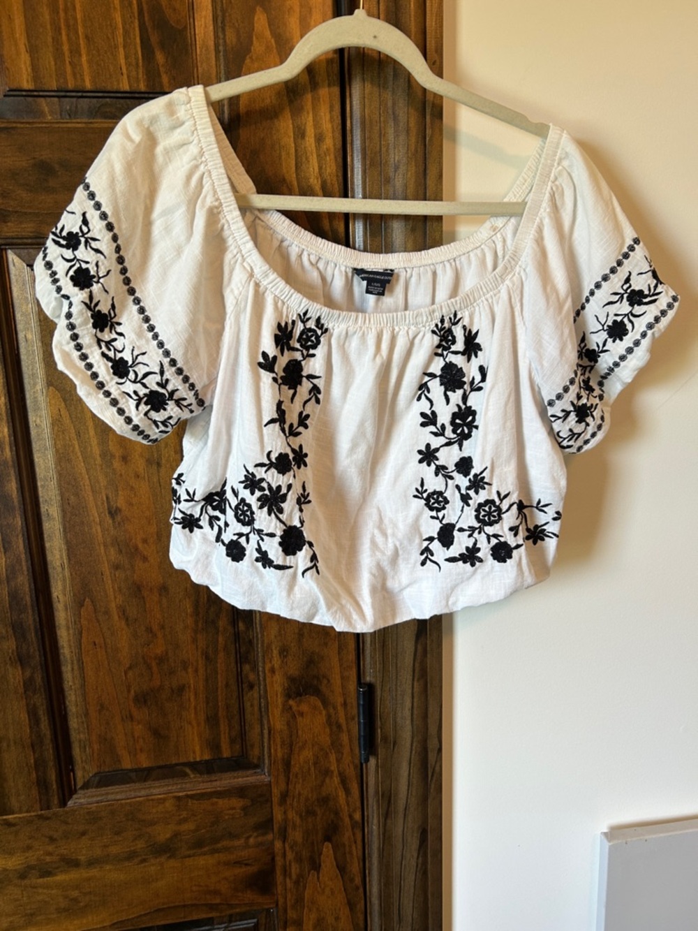 Embroidered White Boho Off-Shoulder Top with Black Floral Detail